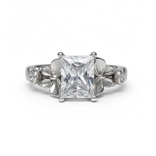 Load image into Gallery viewer, Silver ring with a large central diamond and smaller diamonds on the sides against a white background