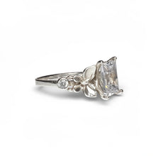 Load image into Gallery viewer, Silver ring with a large diamond and smaller diamonds on a white background